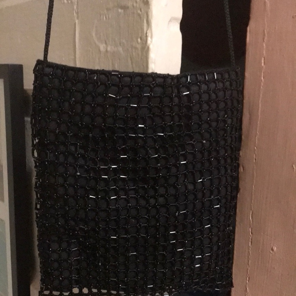 Lovely n like new.  Black beaded bag with square design has satin cord n snaps